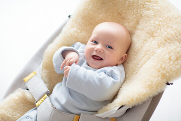 Adorable baby on sheepskin blanket