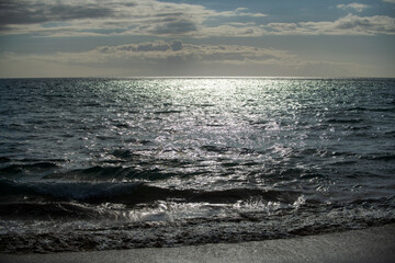 Summer sea background. Texture of water surface. Shining blue water ripple pattern.