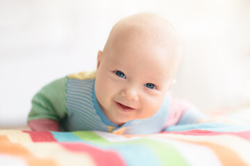 Little baby on white bed