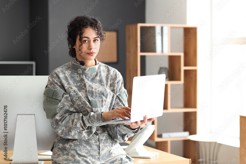 Sticker Female African-American soldier in headset working with laptop at headquarters