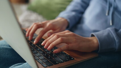 Student hands typing laptop in apartment closeup. Woman working remotely home