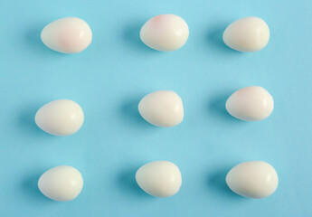 Fresh boiled quail eggs on blue background