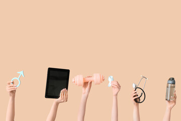 Female hands with male sign, tablet computer, dumbbell and light blue ribbon on beige background. Prostate cancer concept