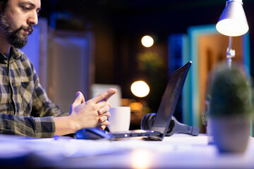 Man working on laptop managing code and programming in artificial intelligence and machine...