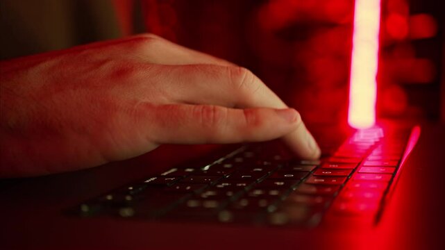 Close up of a man trying to fix an error on a computer in a server room