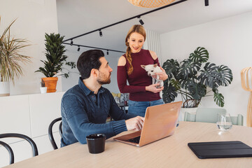 The couple go about their daily chores in the apartment. The couple talks in the kitchen, sits on the sofa, at the dining table.