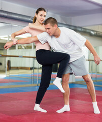 Active girl conducts painful grip on self-defense training in the gym