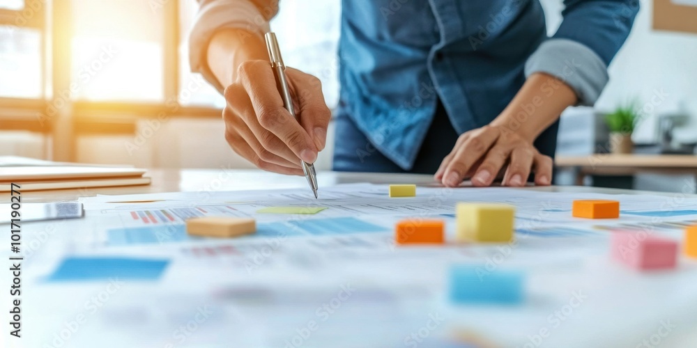 Poster a person analyzing charts and graphs on a table, engaging in strategic planning and brainstorming in