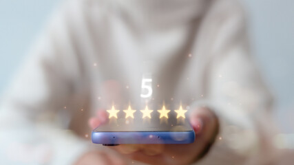 Satisfaction concept. hand of the customer or client holding the stars to complete five stars. with...