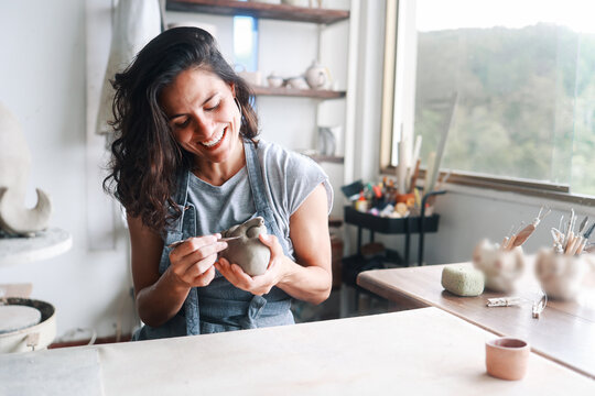 Art business, Artist work with ceramic at clay pottery workshop studio. Woman doing sculpture. Small business, handmade creativity concept