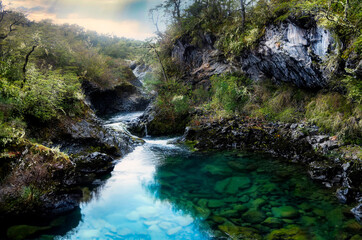 Petrohue Waterfall At Petrohue In Los Lagos Chile. Volcano Landscape. Sky Clouds Background. Los Lagos Chile. Todos Os Santos Mountain. Petrohue Waterfall At Petrohue In Los Lagos Chile.