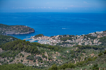 Obraz premium Port Soller Mallorca, view from the distance with the bay, cityscape, sea in the background, horizontal shot, majorca