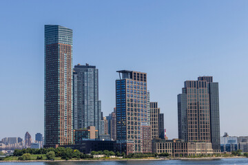 Construction of a modern skyscraper along the waterfront in New York City showcasing urban development
