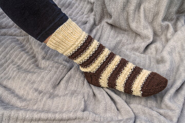 Winter knitted sock on a woman's foot