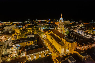 Fototapeta premium Beautiful Aerial view of the walled city of Cartagena de Indias in Colombia. Its Clock Tower entrance, the plaza, the sanctuary and the Domus Dei at night