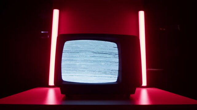 Retro TV, vintage television In a nostalgic setup, a retro TV displays grain on screen, scary halloween night device good for chroma key and green screen.