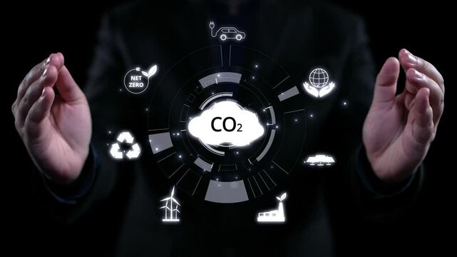 Business person implements initiatives to reduce CO2 emissions, aiming for net zero. Showcases commitment to sustainability by reducing CO2 for a greener planet. UUID