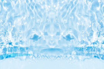 Blue water with ripples on the surface. Defocus blurred transparent blue colored clear calm water surface texture with splashes and bubbles. Water waves with shining pattern texture background.