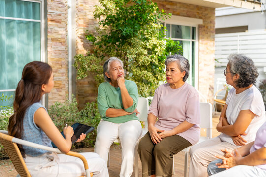 Group of Asian senior mature woman talking discussion about mental health life problem thoughtful with professional psychiatrist in the garden. Elderly people mental health care and therapy concept.