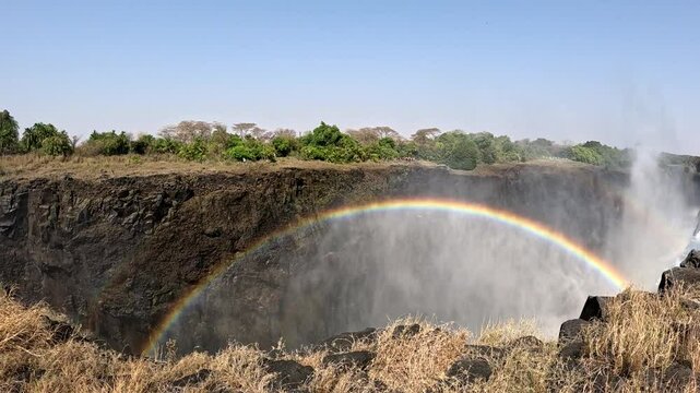 Victoria Falls is a waterfall on the Zambezi River, located on the border between Zambia and Zimbabwe. It is one of the largest waterfalls in the world