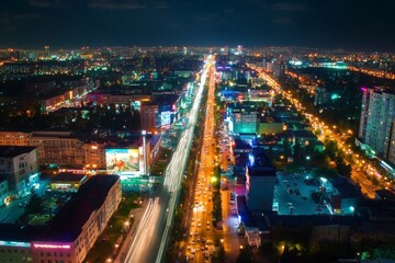 An aerial view of a vibrant city with busy streets and illuminated buildings, night scene