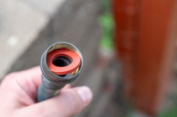 New rubber gasket being replaced in a garden hose female connection to have a water tight coupling.