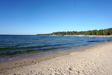 Beach with Blue Adirondack Chair on a Sunny Day in Door County