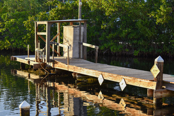 wooden dock on calm water in the evening