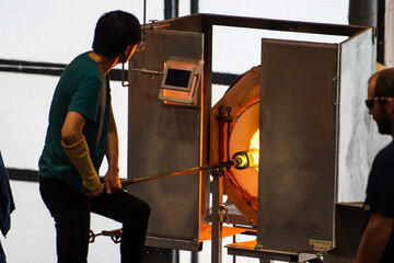 Glass blowing artist with furnace