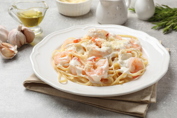 Delicious pasta with shrimps served on light table, closeup