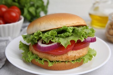 Delicious vegetarian burger with chickpea cutlet on light table, closeup