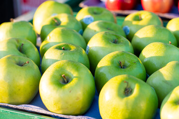Green apples sit on display awaiting purchase