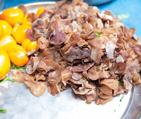 A lot of wood ear mushrooms placed on a stainless steel metal tray.