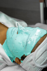 person putting cream on their face