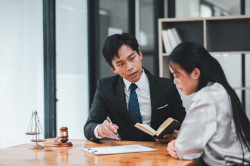 A lawyer in a suit discussing legal matters with a client in a modern office environment, emphasizing professionalism and consultation.