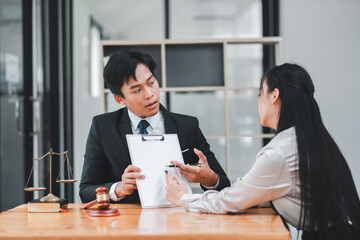 Professional man and woman engaged in a serious business discussion in a modern office environment.