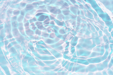 Blue water with ripples on the surface. Defocus blurred transparent blue colored clear calm water surface texture with splashes and bubbles. Water waves with shining pattern texture background.