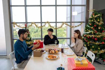 Asian friends come together to celebrate Christmas with a delightful dinner, sharing holiday traditions, festive food, and warm conversations, creating memorable moments of joy and togetherness.