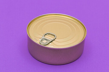Unopened Tin Can with Blank Edge on Violet Background. Canned Food. Aluminum Can for Safe and Long Term Storage of Food. Steel Sealed Food Storage Container