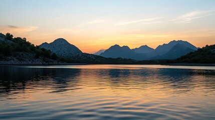 Naklejka premium Serene Sunset Over Mountain Lake - Breathtaking Landscape Photography