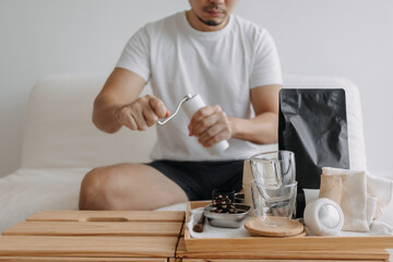 Step by step of Asian man making espresso with hand press tools.