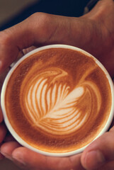 Vertical Close up hands of woman sitting office desk holding sweet coffee cup relax and enjoy with happy time. Vertical Horizon Hot coffee mug in hand. Woman hand holding coffee cup relax at office