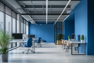 Modern office interior with blue walls, desks, chairs, and large windows.