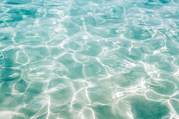 Fototapeta premium Abstract rippling turquoise water with sun reflections.