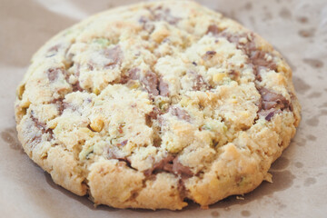 A Deliciously Cracked Chocolate Chip Cookie Presented Beautifully on Parchment Paper