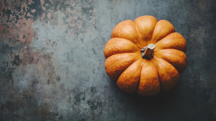 Orange pumpkin isolated on a grunge surface top-down view, ideal for autumn, harvest, thanksgiving, seasonal-themed designs, and promotional material related to fall events