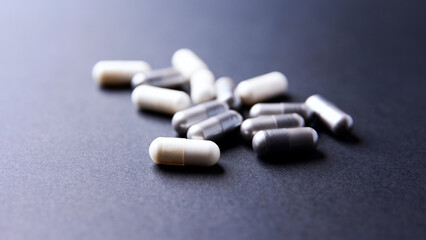 Creatine and BCAA amino acids capsules. Nutrition for bodybuilding. Fitness supplements on paper background. Soft focus. Copy space.	