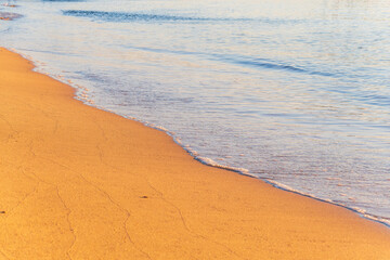 Soft wave of the sea on the sandy beach.