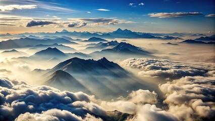 Obraz premium Aerial view of silhouetted clouds floating over tall mountains