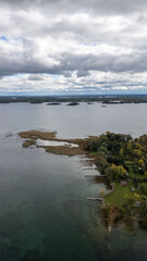 Explore the breathtaking views of the 1000 Islands, where nature meets serenity. This aerial shot captures the lush greenery and sparkling waters of the St. Lawrence River, with tiny, secluded islands